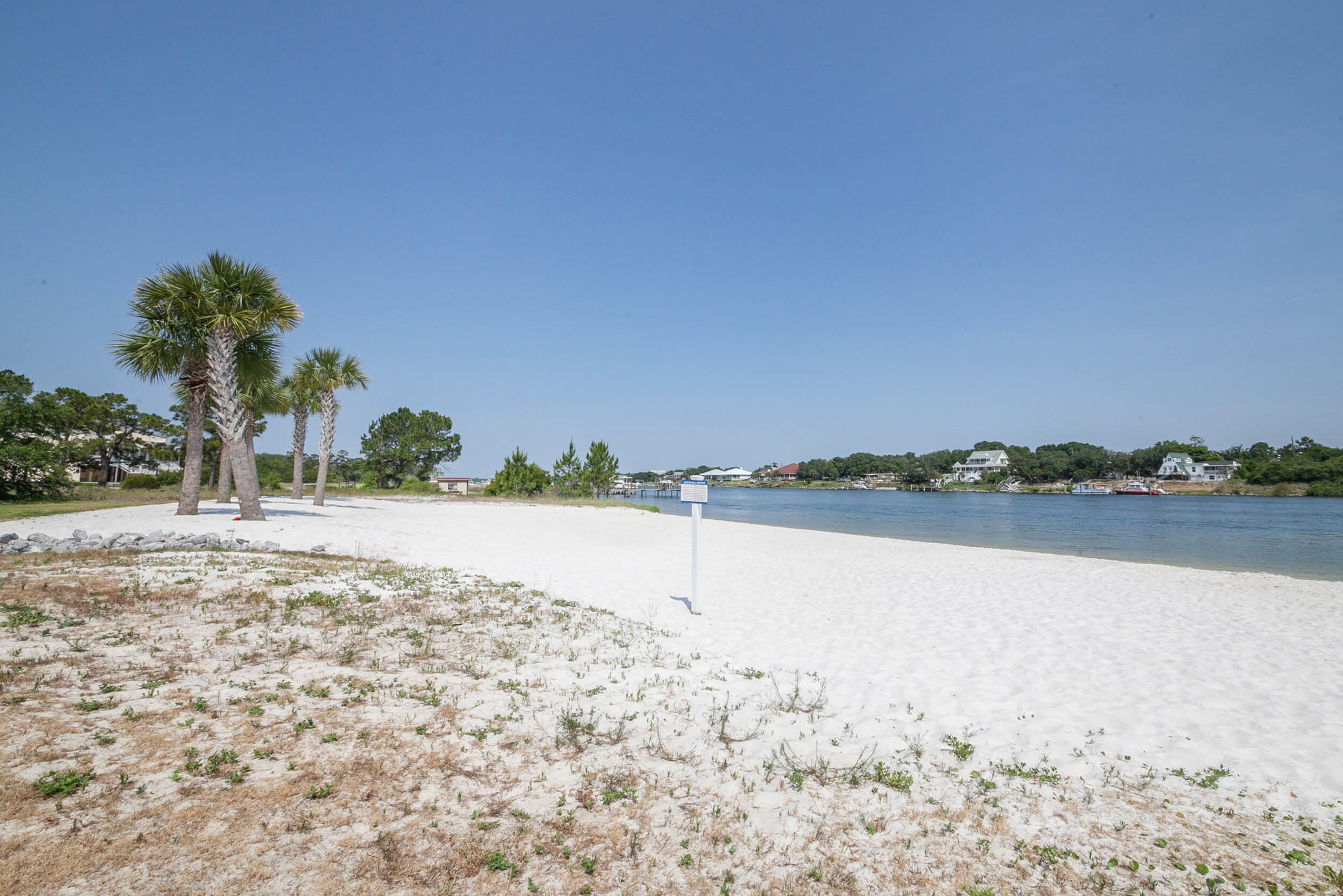 White sandy beach on the Intracoastal waterway at Sailmaker's Place condos in Perdido Key